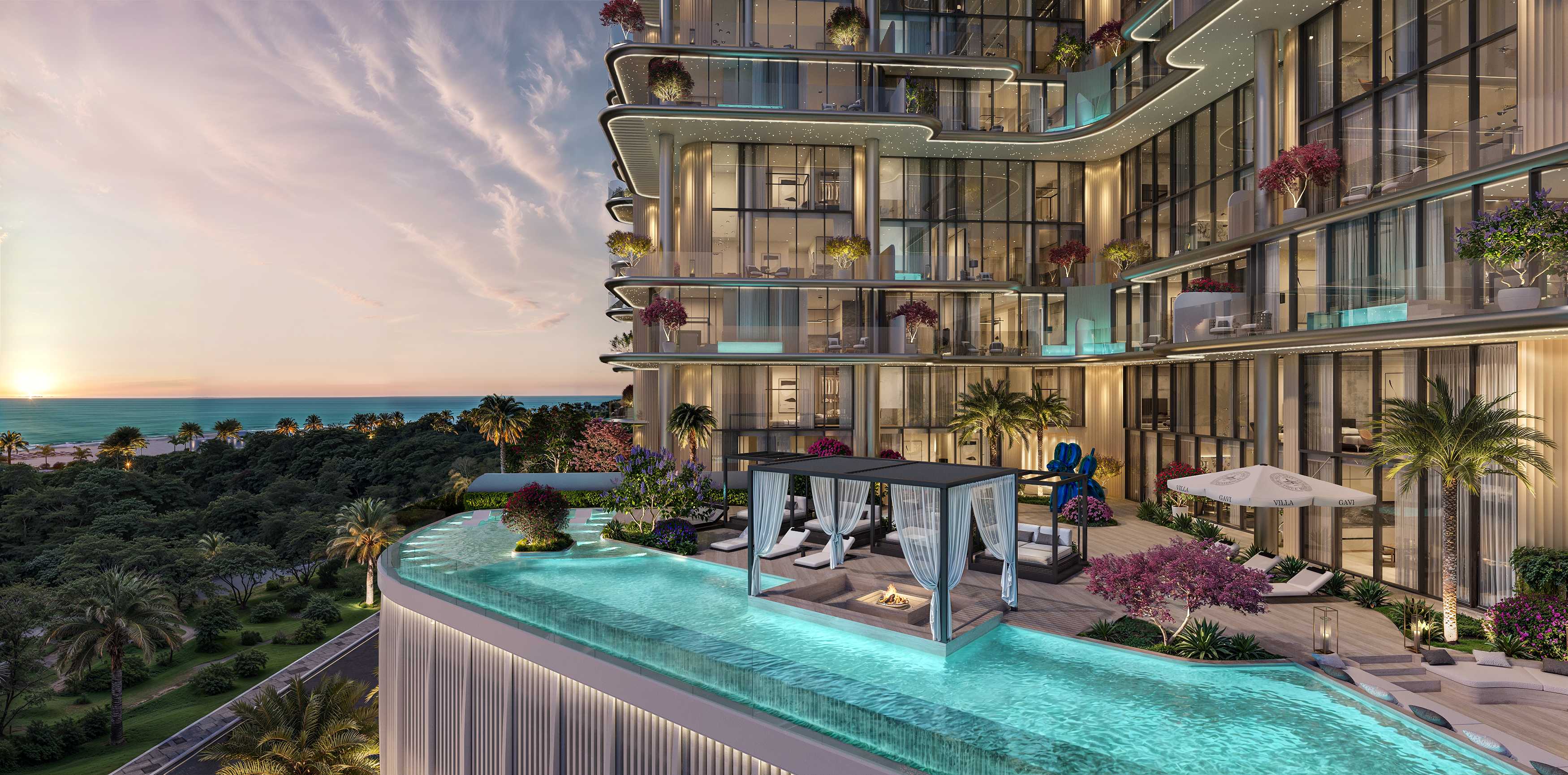 Infinity pool with cabana and fire pit beside the building at sunset