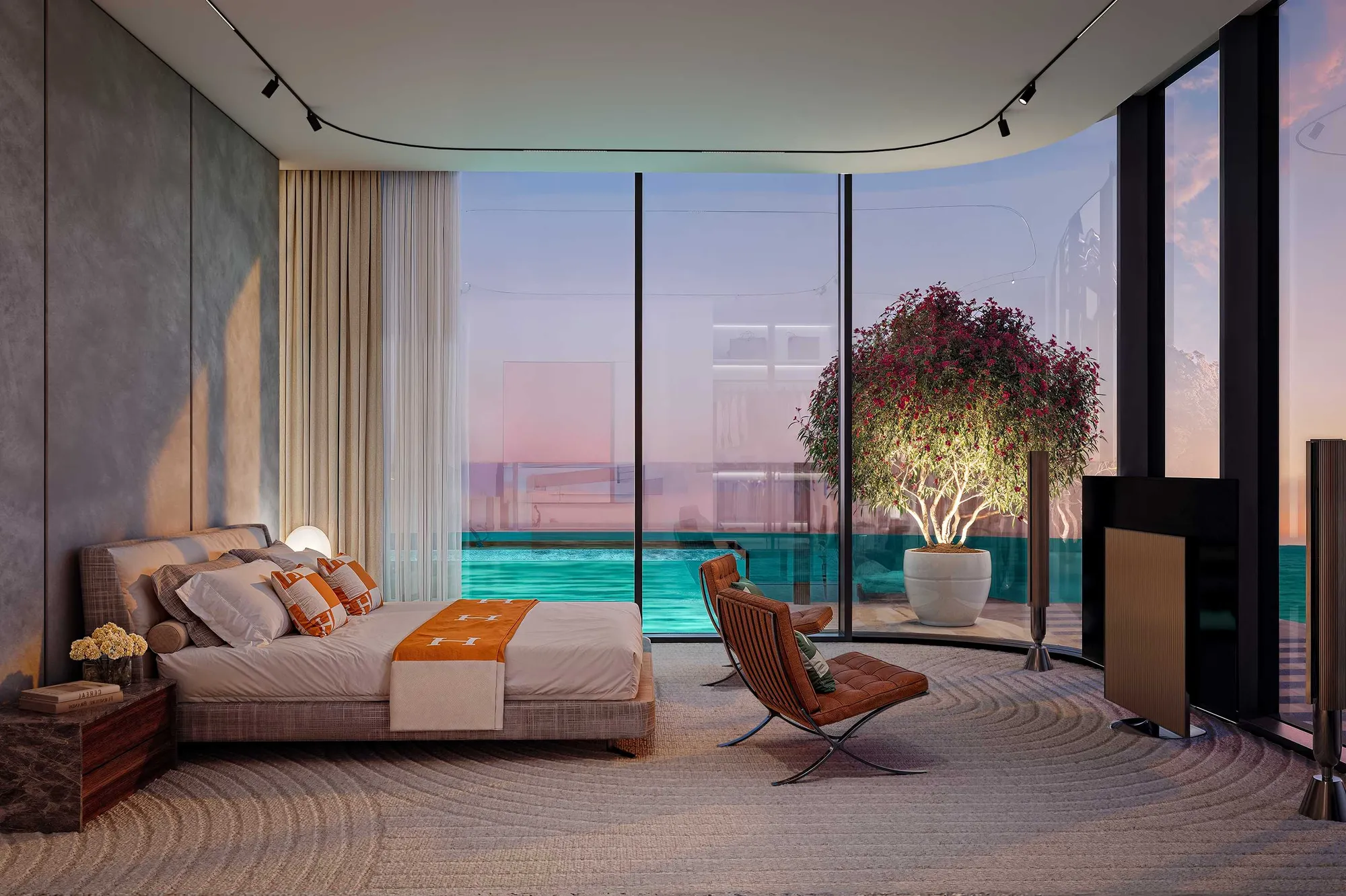 Bedroom with curved glass wall, potted tree and pool beyond